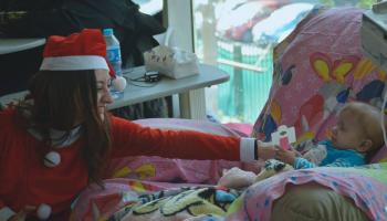 girl in santa cloas clothes plays with childrens