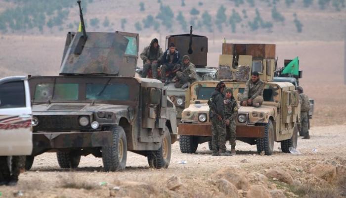 مقاتلون من تحالف قوات سوريا الديمقراطية فوق مركباتهم في جنوب كوباني بسوريا