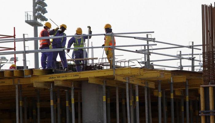 عمال مهاجرون في ورشة بناء بالدوحة- رويترز