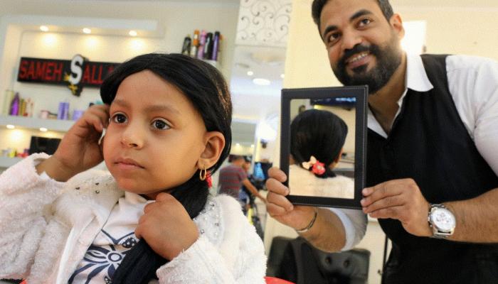 An Egyptian stylist gives children with cancer a wig that raises spirits