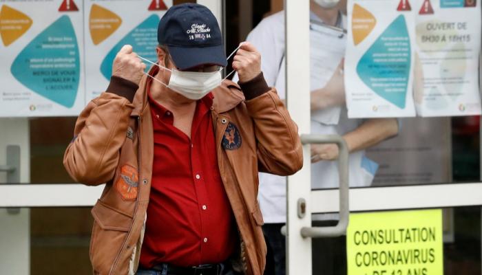 رجل يضع كمامة على فمه للوقاية من فيروس كورونا في فرنسا