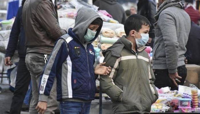 طفلان يضعان كمامات للوقاية من كورونا- أرشيفية