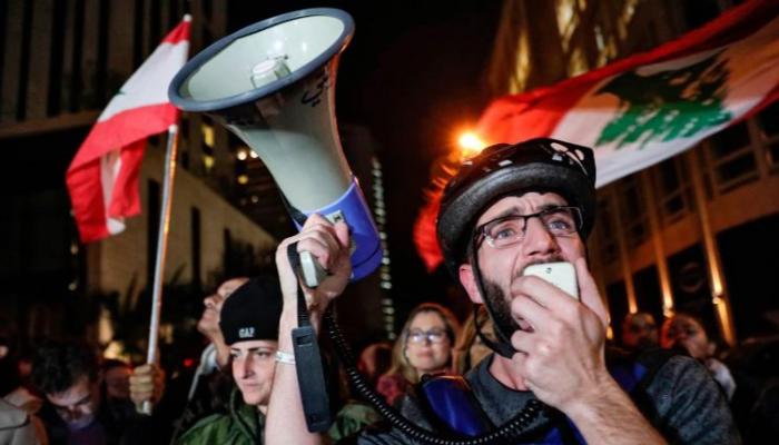 متظاهر لبناني يتحدث بمكبر صوت - سي إن إن