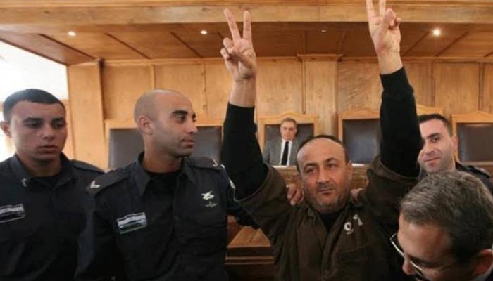 مروان البرغوثي ملوحا بعلامة النصر خلال جلسة محاكمة - أرشيفية