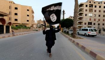 داعشي يحمل علم التنظيم في الرقة (أرشيفية)