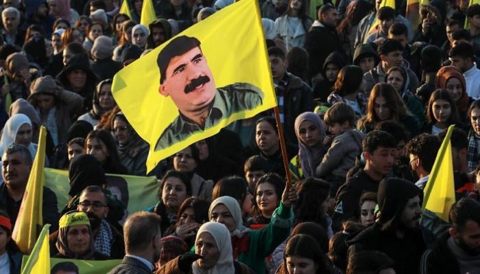 أكراد يلوحون بأعلام تحمل صور مؤسس حزب العمال الكردستاني أوغلان