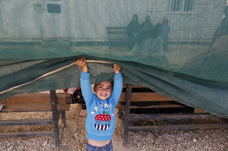 طفل سوري في أحد مخيمات اللاجئين بالأردن (رويترز)