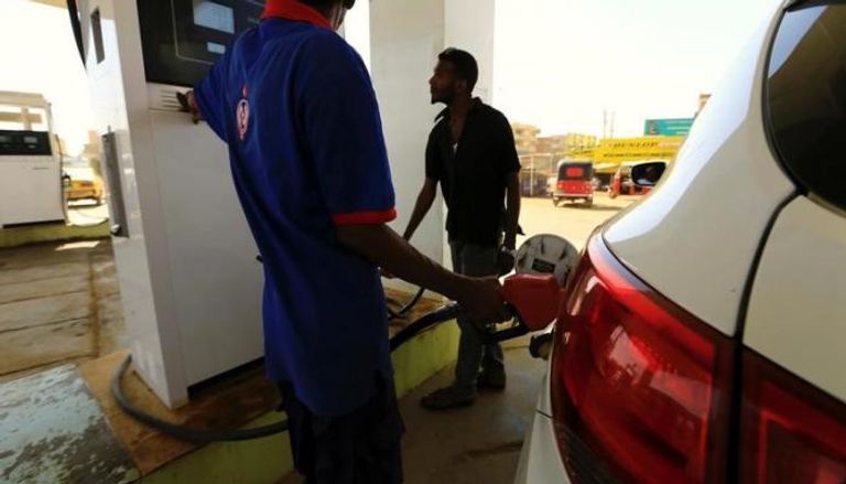 عامل يزود سيارة بالوقود في محطة للوقود في الخرطوم