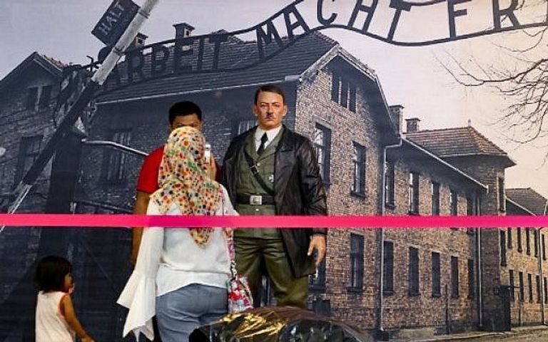 زائرة بالمتحف تلتقط صورة لتمثال هتلر