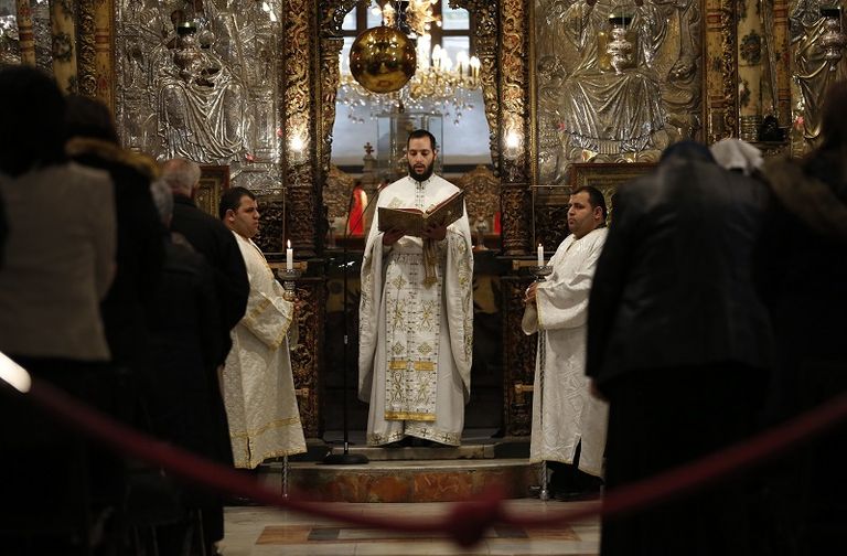 مسيحيون فلسطينيون يحضرون صلاة عيد الميلاد في كنيسة المهد 24 ديسمبر- الفرنسية  