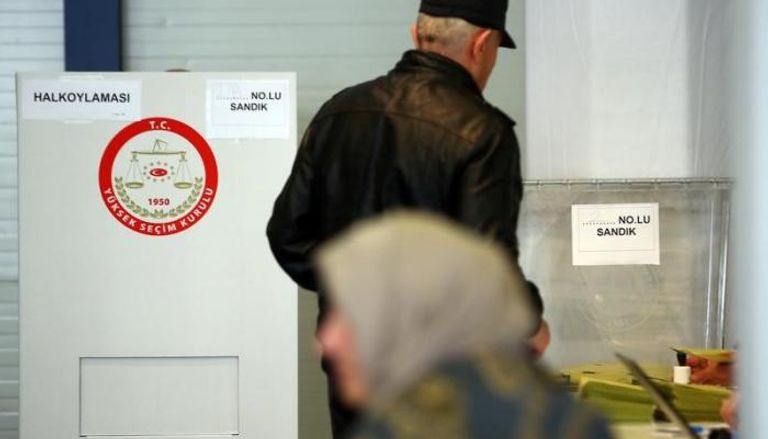رجل وامرأة تركيان في مركز اقتراع في ألمانيا