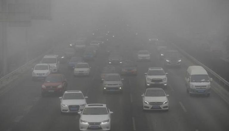 سيارات تنطلق وسط الضباب الدخاني في بكين
