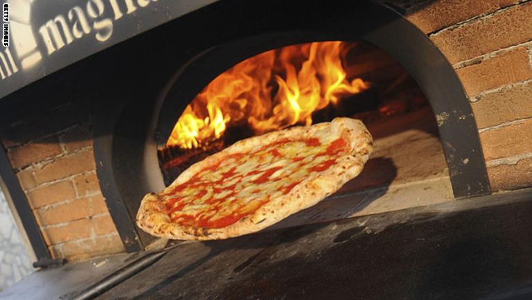 أطفال يشاركون في صنع البيتزا بأحد المحال