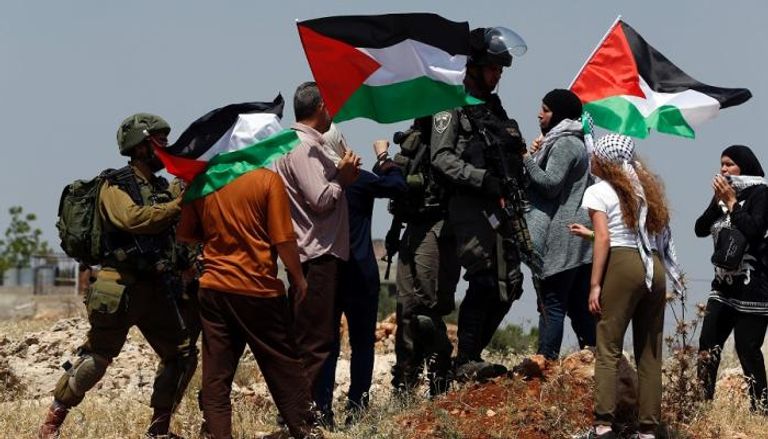 فلسطينيون في مسيرة برام الله
