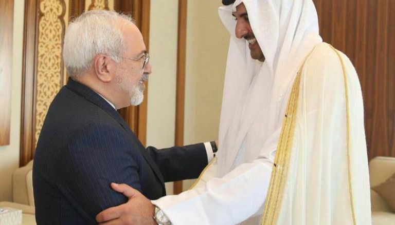 أمير قطر تميم بن حمد ووزير الخارجية الإيراني جواد ظريف