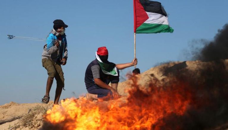 شبان يرشقون جيش الاحتلال بالحجارة في مواجهات بالضفة الغربية - رويترز
