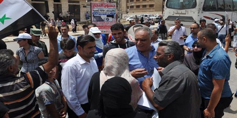 صور نشرتها وكالة سانا لعودة عناصر من المعارضة المسلحة لحمص صور المسلحين حين رحيلهم من حمص إلى شمال سوريا