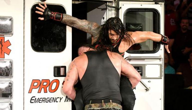 برون سترومان يحاول إدخال رومان رينز سيارة الإسعاف