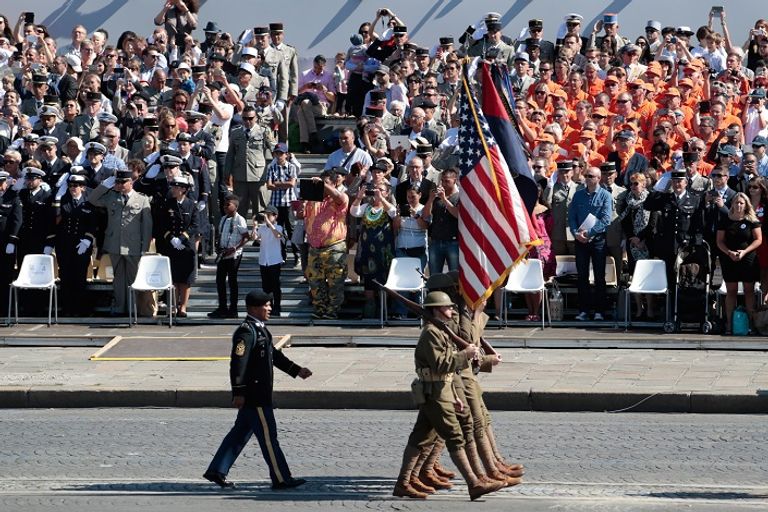 ماكرون خلال حضوره العرض العسكري- رويترز