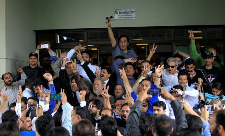 معارضون يهتفون فرحا بعد قرار المحكمة إسقاط الشرعية عن شريف معارضون يحرقون صورا لرئيس الوزراء الباكستاني (الفرنسية)