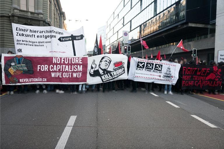 جانب من المسيرة التي نظمها المحتجون للبرلمان السويسري المحتجون ارتدوا الملابس السوداء احتجاجا على زيارة ترامب