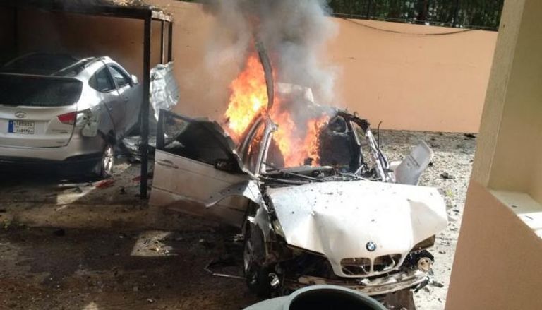 صورة تناقلتها وسائل إعلام لبنانية للسيارة التي تم تفجيرها رجال الإسعاف خلال محاولة إطفاء النيران المشتعلة بسيارة حمدان - أرشيفية