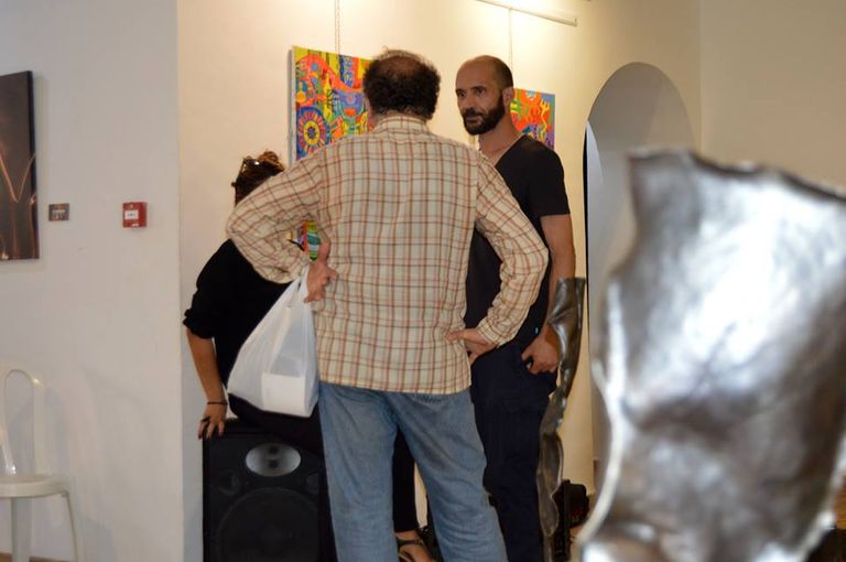 الفنان عبد الغني شلوش في الوسط معرض لفن النحت على المعادن في الجزائر