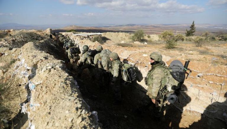 جنود أتراك يسيرون في إحدى ضواحي عفرين - رويترز