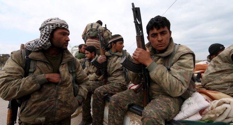 مقاتلون بوحدات الحماية الكردية الرئيسان التركي رجب أردوغان والسوري بشار الأسد