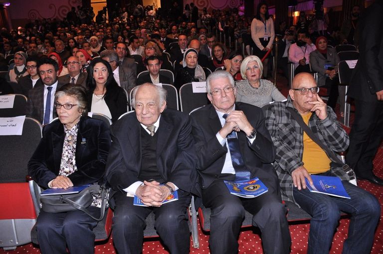 الفنانة ليلى طاهر إلى جوار لافتة المهرجان