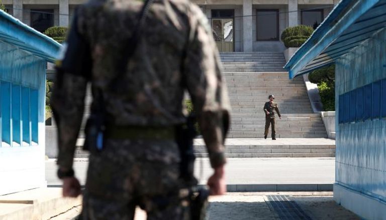 صورة لجنود من الكوريتين يقفون على الشريط الحدودي- رويترز
