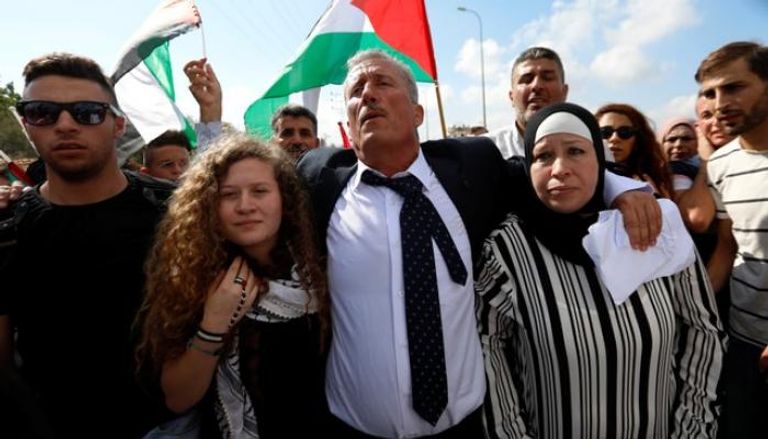 عهد مع والديها بعد الإفراج عنها  جدارية عهد التميمي