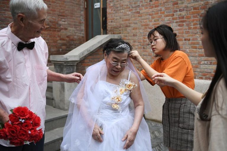 مسنون صينيون بملابس الزفاف في عيد الحب