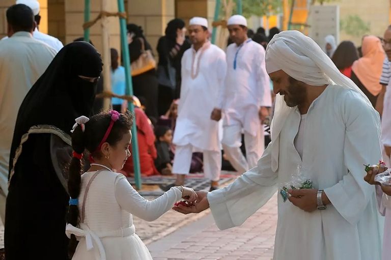 توزيع الحلوى على الصغار في السعودية مهرج يوزع بالونات على الأطفال قرب مصلى مسجد قبة الصخرة