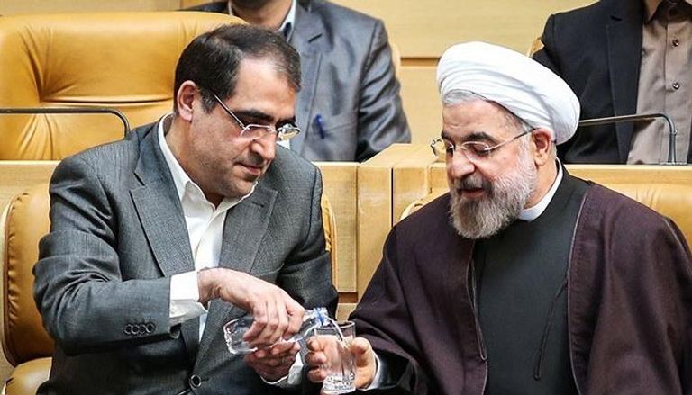 هاشمي إلى جوار الرئيس الإيراني حسن روحاني - أرشيفية