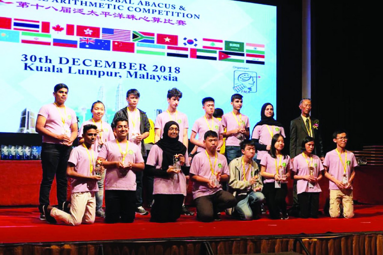 نورة اليافعي تتوسط الفائزين في مسابقة الحساب الذهني