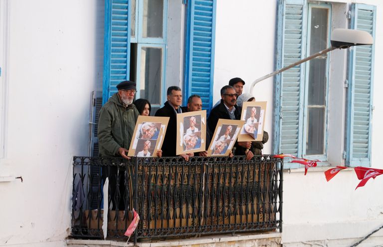 متظاهرون يحملون علم اتحاد الشغل التونسي - رويترز