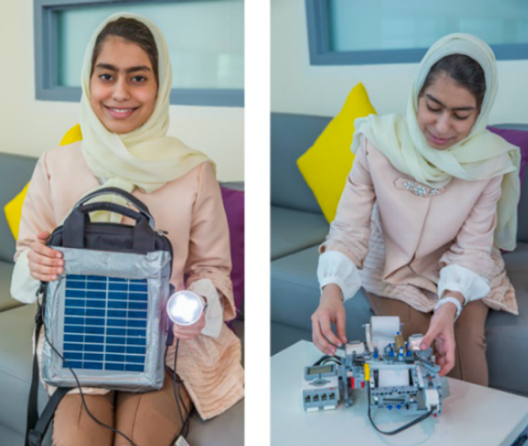 الطالبة فاطمة الكعبي تجري تجاربها على روبوت