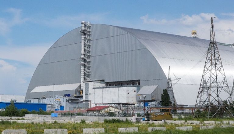 تشرنوبل (أوكرانيا): الملاذ الواقي الجديد حول بقايا مفاعل تشرنوبل الوحدة الرابعة في محطة تشرنوبل النووي والذي يمكن رؤيته من نافذة حافلة في تشرنوبل بأوكرانيا. إحدى المناطق المهجورة في تشرنوبل