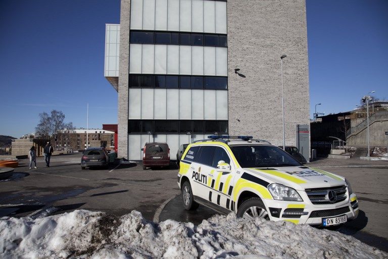 أحد أفراد الشرطة النرويجية أمام المدرسة