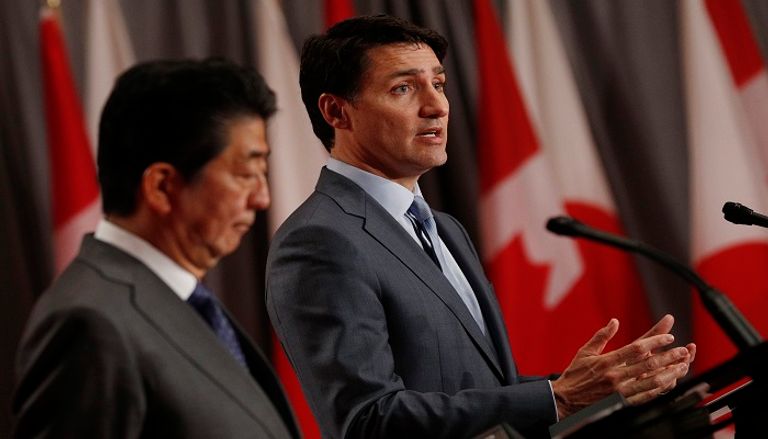 جاستن ترودو وشينزو آبي - الفرنسية