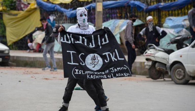 متظاهر كشميري يحمل راية "داعش" في مدينة سريناجار