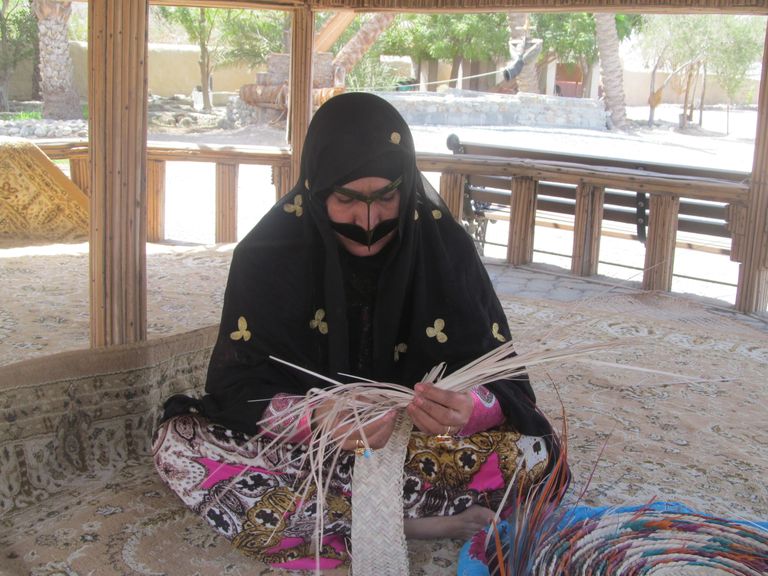 "أم سيف" مُطلعةً على أحد المراجع.