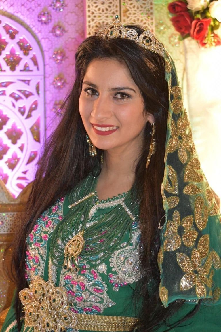 كاميليا قجاج بجانب إحدى لوحاتها