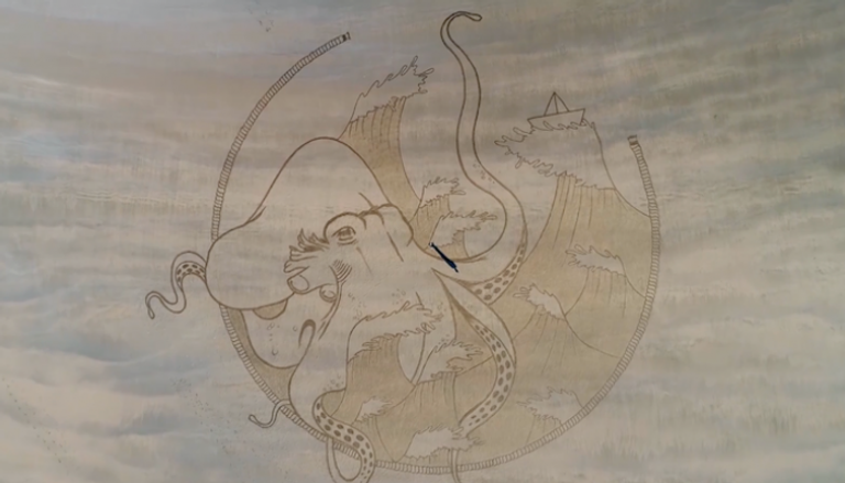 رسمة لأخطبوط بين الأمواج وزورق ورقي