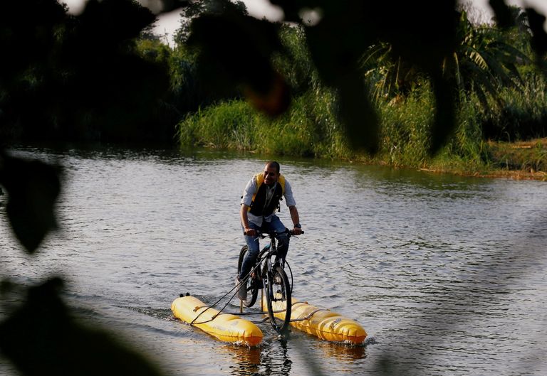 مصريون يستمتعون بالتجول فوق سطح النيل بالدراجات