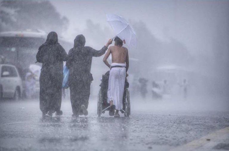 جندي يحمل شيخاً لمساعدته على أداء المناسك