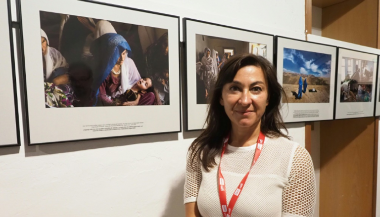 الصحفية لينزي أداريو أمام صورها في مهرجان "فيزا بورليماج"
