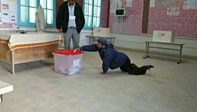 ناخب تونسي من ذوي الاحتياجات الخاصة يدلي بصوته في الانتخابات 