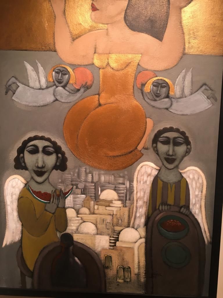 مصطفى رحمة بجوار إحدى لوحاته